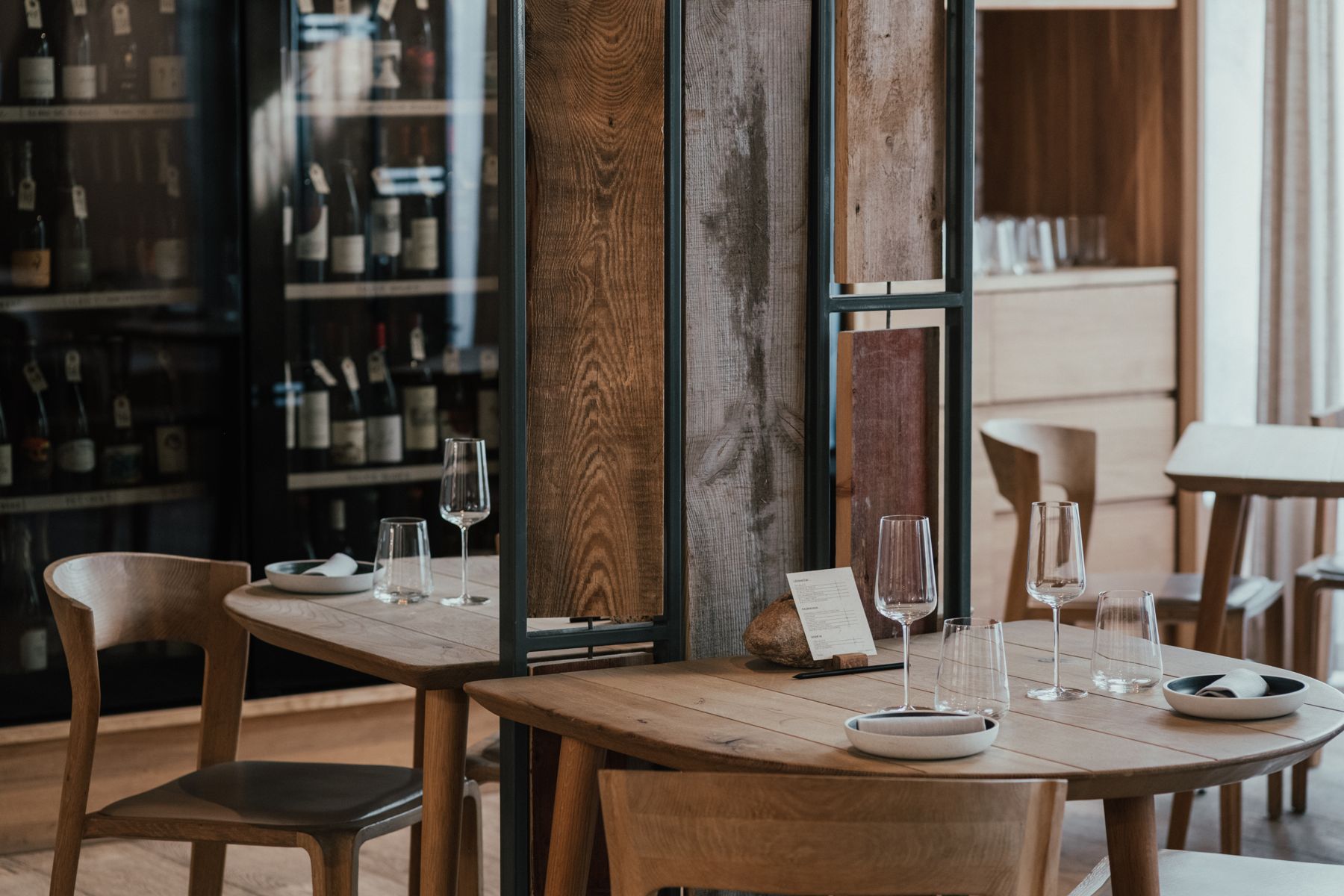 Tables in front of the wine wall